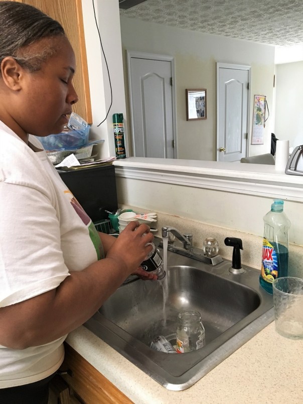 Empish Rinsing Containers in Sink