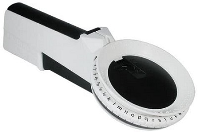 A black and white braille label gun with turn dial displaying both braille and print letters and numbers.
