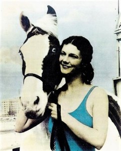 Color photo of Sonora Webster Carver posing with her horse