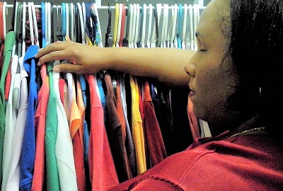 Empish selecting clothes in closet