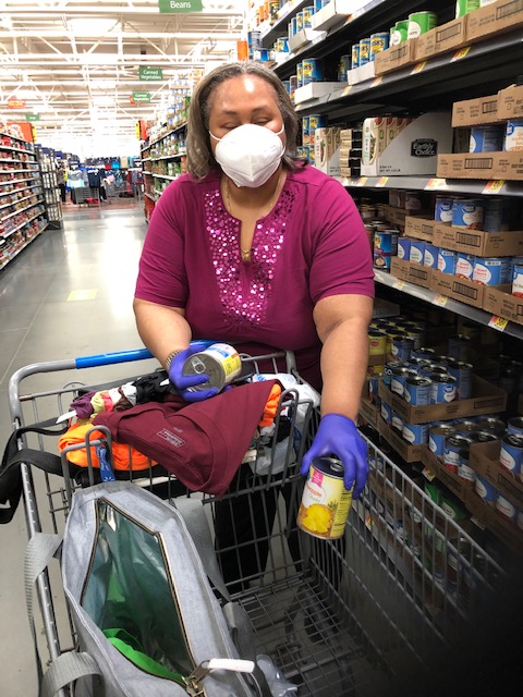 Empish grocery shopping wearing a facemask