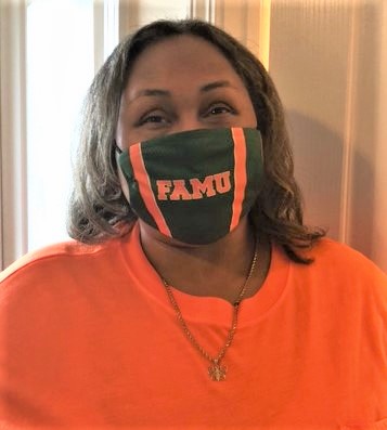 Empish wearing orange top with her college alumni, Florida A&M University, facemask