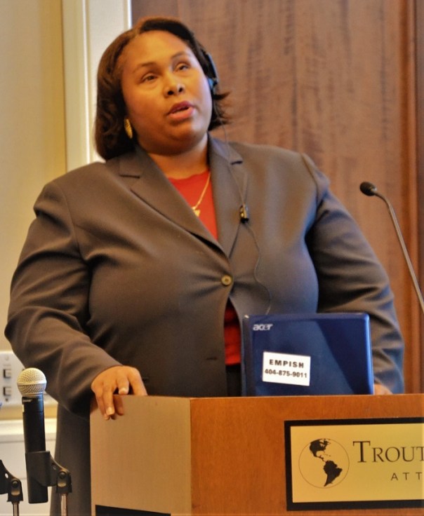 Empish speaking at podium during her diversity capstone presentation