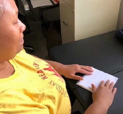Empish Reading Braille Calendar with Her Fingers