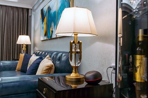 Two white and gold lamps in a living room.